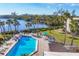 Community pool featuring many chairs for lounging with a gorgeous lake view at 225 Hourglass Way # 306, Sarasota, FL 34242