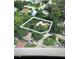 An aerial view shows the home is surrounded by lush greenery in a lovely neighborhood at 2290 Clematis St, Sarasota, FL 34239