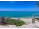 Gorgeous ocean view with weathered posts, dune vegetation, and crystal blue skies above at 2290 Clematis St, Sarasota, FL 34239
