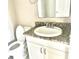 Bathroom vanity features granite counters, a white sink, and white cabinets at 2938 Clark Rd # 203, Sarasota, FL 34231