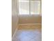 Bright bedroom corner with a window that has blinds, tiled floor, and neutral walls at 2938 Clark Rd # 203, Sarasota, FL 34231