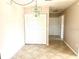 Dining area with a modern light fixture and white bi-fold doors leading to storage at 2938 Clark Rd # 203, Sarasota, FL 34231