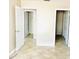 Hallway with multiple doorways leading to other rooms, tiled flooring, and neutral paint at 2938 Clark Rd # 203, Sarasota, FL 34231