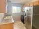 Functional kitchen featuring wooden cabinetry, stainless steel refrigerator, and granite countertops at 2938 Clark Rd # 203, Sarasota, FL 34231