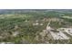 High aerial view of secluded home, detached garage, and wooded surroundings of property at 31860 Taylor Grade Rd, Duette, FL 34219