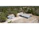 Aerial view of property showing home, detached garage, and surrounding wooded acreage at 31860 Taylor Grade Rd, Duette, FL 34219