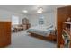 Bright bedroom with neutral carpet, ceiling fan and large window providing ample natural light at 31860 Taylor Grade Rd, Duette, FL 34219