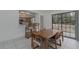 A dining room features a wooden table, four chairs, a breakfast bar, and a sliding glass door at 31860 Taylor Grade Rd, Duette, FL 34219