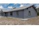 Charming exterior of home with modern siding, metal roof, and gravel landscaping at 31860 Taylor Grade Rd, Duette, FL 34219
