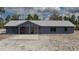 Charming single-story home featuring a metal roof, covered porch and xeriscaped front yard at 31860 Taylor Grade Rd, Duette, FL 34219