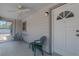 A quaint screened-in porch with a ceiling fan, a swing, and a view of the front yard at 31860 Taylor Grade Rd, Duette, FL 34219