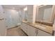 Modern bathroom with dual sinks, granite countertops, and glass-enclosed shower at 3409 Montilla Ct # 8410, Sarasota, FL 34232