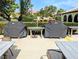Outdoor grilling area featuring two covered Weber grills and outdoor seating at 3409 Montilla Ct # 8410, Sarasota, FL 34232