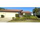Inviting single-story home with red tile roof, flowerbeds, and a private gated entrance at 3409 Montilla Ct # 8410, Sarasota, FL 34232