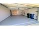 Spacious garage with epoxy flooring, storage cabinets, and updated lighting fixtures at 3409 Montilla Ct # 8410, Sarasota, FL 34232