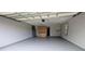 Clean and bright garage featuring a durable epoxy floor, convenient storage cabinets, and a window at 3409 Montilla Ct # 8410, Sarasota, FL 34232