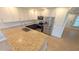 Modern kitchen featuring granite countertops, stainless steel appliances, and white and blue cabinets at 3409 Montilla Ct # 8410, Sarasota, FL 34232
