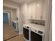 Bright laundry room with cabinetry and new washer and dryer at 3409 Montilla Ct # 8410, Sarasota, FL 34232