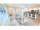 Open-concept living area and kitchen with white cabinets, stainless steel appliances, and breakfast bar at 3409 Montilla Ct # 8410, Sarasota, FL 34232