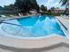 Large community pool surrounded by lounge chairs at 3409 Montilla Ct # 8410, Sarasota, FL 34232