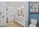 Modern bathroom with double vanity, framed mirrors, and a glass-enclosed shower at 3443 74Th Avenue E Cir, Sarasota, FL 34243