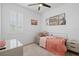 Cozy bedroom with a single bed, charming decor, and a bright window with shutter blinds at 3443 74Th Avenue E Cir, Sarasota, FL 34243