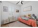 Bright bedroom with plush rug, a single bed, shuttered window and two sets of drawers at 3443 74Th Avenue E Cir, Sarasota, FL 34243