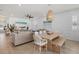 Open-concept dining area with a modern table, seating, and views into the living room at 3443 74Th Avenue E Cir, Sarasota, FL 34243