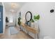 Charming entryway with decorative console table, round mirror, and stylish light fixtures at 3443 74Th Avenue E Cir, Sarasota, FL 34243