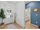 Bright entryway features wood-look floors, a modern front door, and stylish decor leading to the bathroom at 3443 74Th Avenue E Cir, Sarasota, FL 34243