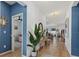 Bright hallway with wood floors that leads into the main living areas, complemented by modern lighting at 3443 74Th Avenue E Cir, Sarasota, FL 34243