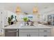 Contemporary kitchen with island seating, opening to living and dining areas for seamless entertaining at 3443 74Th Avenue E Cir, Sarasota, FL 34243