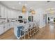 Contemporary kitchen featuring a large island with seating, white cabinets, and stainless steel appliances at 3443 74Th Avenue E Cir, Sarasota, FL 34243