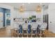 Open-concept kitchen featuring white cabinets, a center island with seating, and stainless steel appliances at 3443 74Th Avenue E Cir, Sarasota, FL 34243