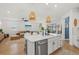 Bright, open kitchen with an island, stainless steel appliances, and seamless flow to the living space at 3443 74Th Avenue E Cir, Sarasota, FL 34243