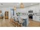 Modern kitchen with white cabinets, a large island with seating, and stainless steel appliances at 3443 74Th Avenue E Cir, Sarasota, FL 34243