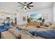 Bright and airy living room featuring an oversized sectional, ceiling fan, and views of the kitchen at 3443 74Th Avenue E Cir, Sarasota, FL 34243