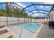 Screened pool area featuring a crystal-clear pool, lounge chairs, and outdoor dining set at 3443 74Th Avenue E Cir, Sarasota, FL 34243
