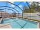 Sparkling swimming pool with screened enclosure, lush landscaping, and a playhouse at 3443 74Th Avenue E Cir, Sarasota, FL 34243