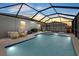 Inviting screened-in pool area with comfortable seating, a dining set, and a grill for outdoor entertaining at 3443 74Th Avenue E Cir, Sarasota, FL 34243