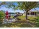 Backyard with an outdoor dining set and a well-manicured lawn offering plenty of space for outdoor activities at 3459 Lotus Rd, North Port, FL 34291