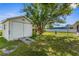 Backyard featuring a storage shed, green grass, and mature shade tree, creating an inviting outdoor space at 3459 Lotus Rd, North Port, FL 34291