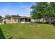 Spacious backyard featuring a well-maintained lawn and screened-in patio perfect for entertaining at 3459 Lotus Rd, North Port, FL 34291