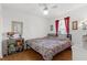Bedroom with ceiling fan, wood floors, and a large window at 3459 Lotus Rd, North Port, FL 34291