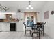 Bright and airy kitchen with white cabinets and a cozy dining area by the window at 3459 Lotus Rd, North Port, FL 34291