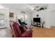 Bright living room with hardwood floors, decorative accents, and large windows at 3459 Lotus Rd, North Port, FL 34291