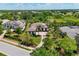 Sprawling single-Gathering home with tile roof, circular drive, mature trees and verdant landscaping at 3519 Founders Club Dr, Sarasota, FL 34240