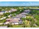 Stunning aerial view of luxurious homes, a pond, and lush greenery in a vibrant community at 3519 Founders Club Dr, Sarasota, FL 34240