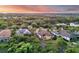 Overhead view of a luxury home featuring a screened-in lanai and a lush, green yard at 3519 Founders Club Dr, Sarasota, FL 34240