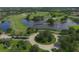 Scenic aerial shot showcasing the community's expansive golf course and serene lake at 3519 Founders Club Dr, Sarasota, FL 34240